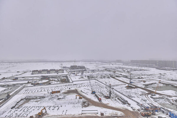 View from the window at the construction site in winter . High quality photo