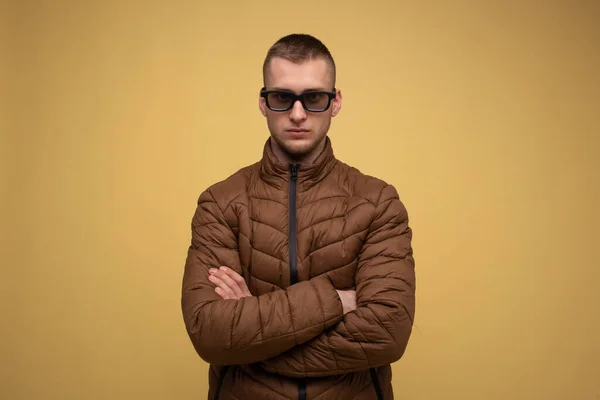Young Man 20S Brown Jacket Yellow Background Sad Glasses Watching — Fotografie, imagine de stoc