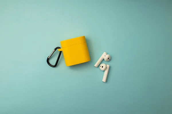 Bright musical headphones lie on a blue background