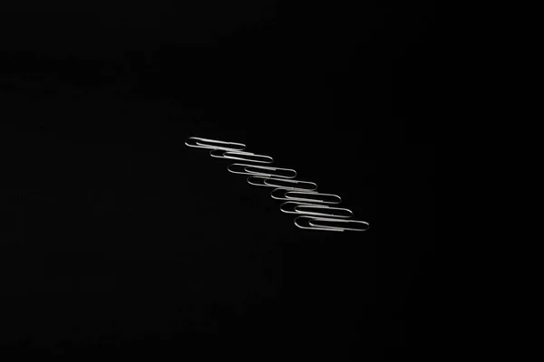 Metal Paper Clips Lie Black Background — Stockfoto