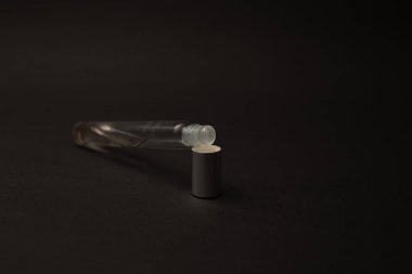 Arka planda cam ayaklıklardan yapılmış parfüm şişesi.