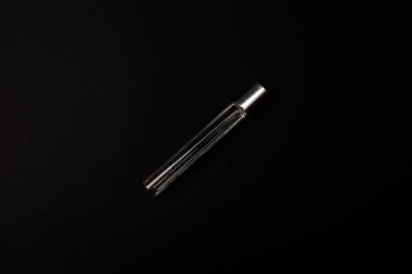 Arka planda cam ayaklıklardan yapılmış parfüm şişesi.