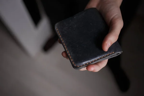 Man holding a leather wallet