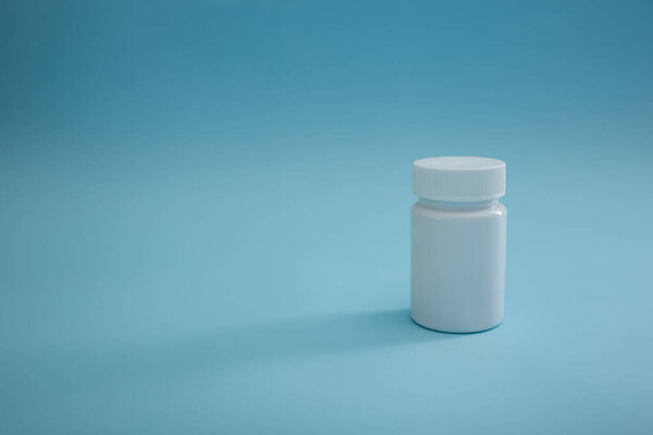 Medical packaging of pills on a blue background, a cure for the disease