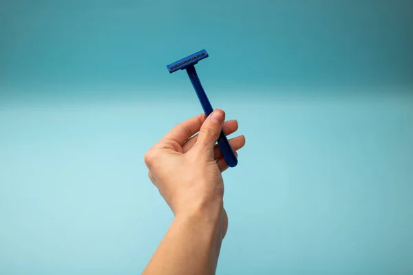 Disposable shaver razor isolated on blue background