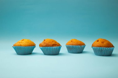 Mavi arka planda mavi ambalajlı parlak kekler