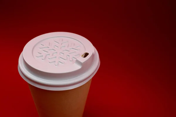 Disposable plastic cup on a red background