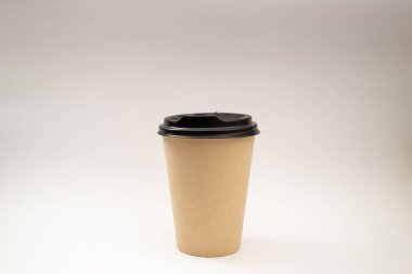 Beige plastic cup with black lid
