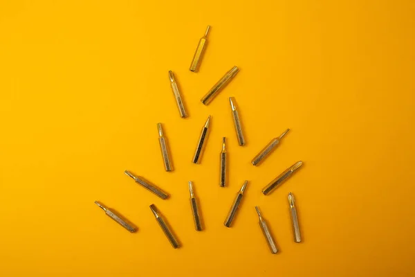 Small Screwdriver Bits Yellow Background — 스톡 사진