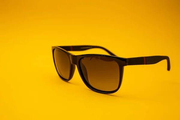 Black Sunglasses Orange Background — стоковое фото