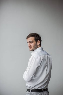 Georgian businessman standing against a white wall