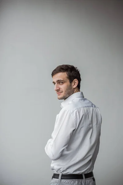 Beyaz bir duvara karşı duran Gürcü işadamı