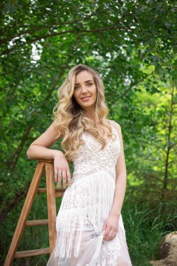 A bride on a ranch in a white dress and boots