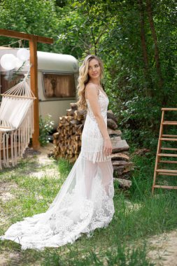 A bride on a ranch in a white dress and boots