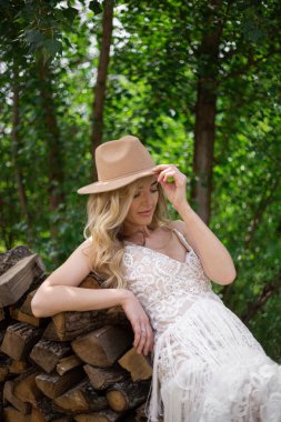 A bride on a ranch in a white dress and boots
