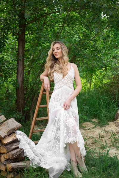 Blond girl in a white wedding dress