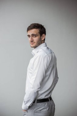 Georgian businessman standing against a white wall
