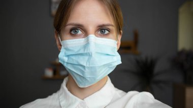 Young girl nurse in a white coat