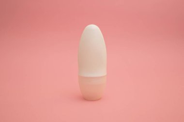 Roller deodorant antiperspirant on a pink background