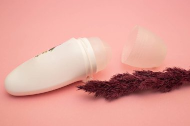 Roller deodorant antiperspirant on a pink background