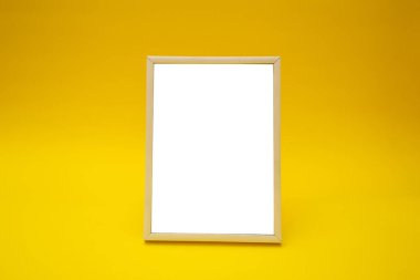 White photo frame on yellow background