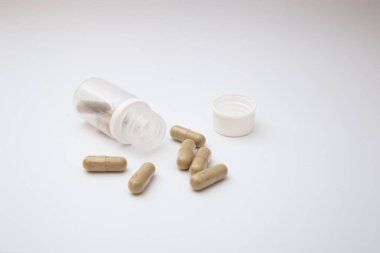 Pills with the badas, dietary supplement on a white background