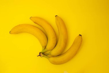 Bananas on yellow background, monochrome