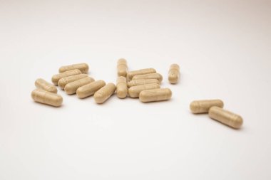 Pills with the badas, dietary supplement on a white background