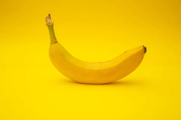Bananas on yellow background, monochrome