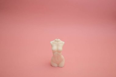Candles with white wax on a pink background
