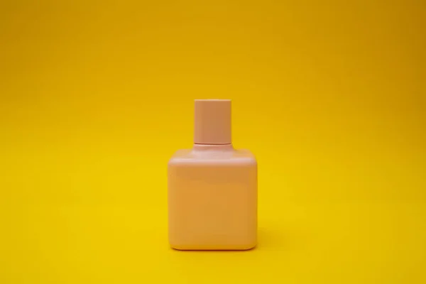 Pink Bottle Perfume Yellow Background — стоковое фото