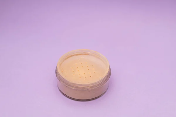 Facial Powder on Purple Background