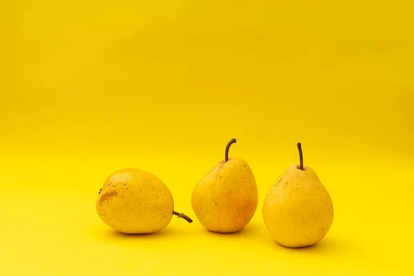 Yellow pears on a yellow background