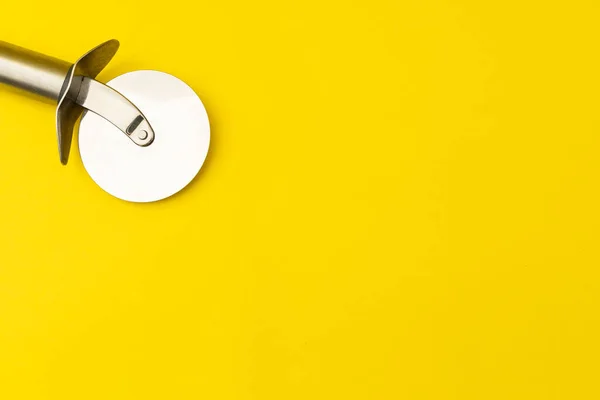 stock image Pizza cutter on yellow background