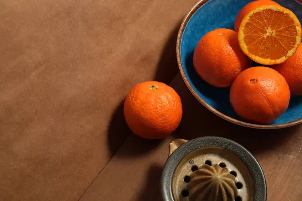 Still life with oranges on blue plate over wooden board. Concept of natural and rustic life.