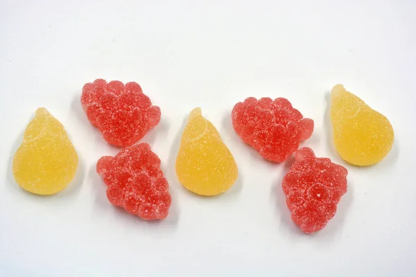 Beautiful and colorful sweet jelly candies made from natural juice in the form of natural fruits: pears, apples, raspberries, orange slices, watermelon and lemon.