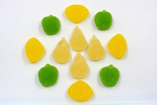 Beautiful and colorful sweet jelly candies made from natural juice in the form of natural fruits: pears, apples, raspberries, orange slices, watermelon and lemon.