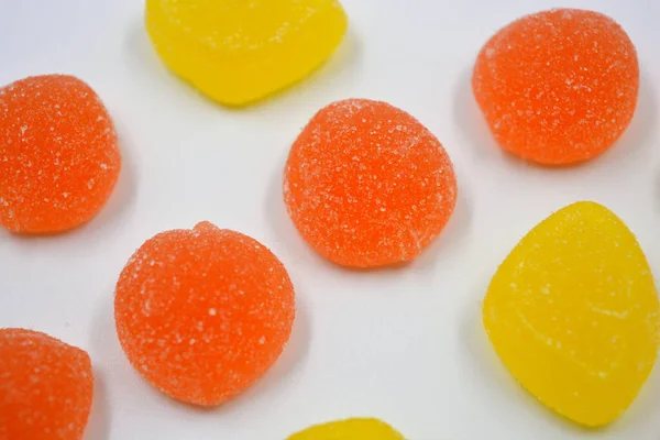 Beautiful and colorful sweet jelly candies made from natural juice in the form of natural fruits: pears, apples, raspberries, orange slices, watermelon and lemon.