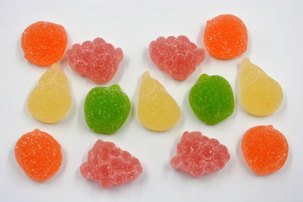 Beautiful and colorful sweet jelly candies made from natural juice in the form of natural fruits: pears, apples, raspberries, orange slices, watermelon and lemon.