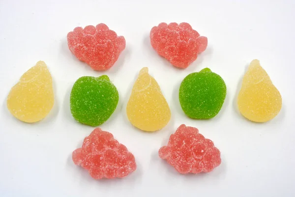 Beautiful and colorful sweet jelly candies made from natural juice in the form of natural fruits: pears, apples, raspberries, orange slices, watermelon and lemon.