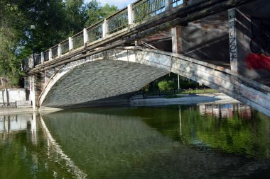 Central city, family amusement park with beautiful landscaping. The park has lake, water theatre, bridge, trees, park areas, shops, monuments, protected areas is Lazar Globa Park. Houses, buildings and sights of the city of Dnipro, Ukraine.