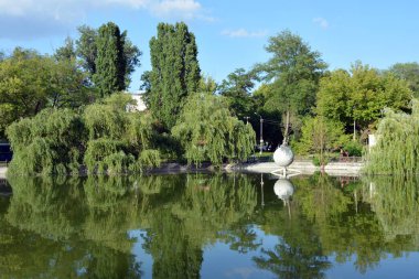 Central city, family amusement park with beautiful landscaping. The park has lake, water theatre, bridge, trees, park areas, shops, monuments, protected areas is Lazar Globa Park. Houses, buildings and sights of the city of Dnipro, Ukraine.