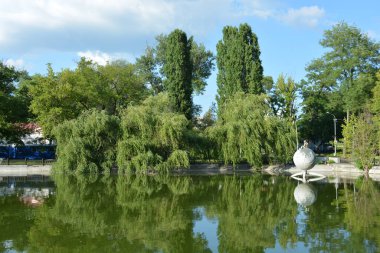 Central city, family amusement park with beautiful landscaping. The park has lake, water theatre, bridge, trees, park areas, shops, monuments, protected areas is Lazar Globa Park. Houses, buildings and sights of the city of Dnipro, Ukraine.