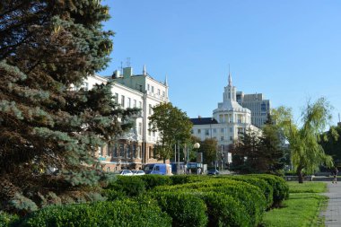 Buildings and buildings, interesting streets, trees - landscape design in the center of the city of Dnipro, near the Dnipropetrovsk Academic Opera and Ballet Theatre, Ukraine.