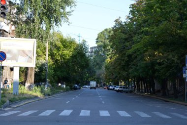 Buildings and buildings, interesting streets, trees - landscape design in the center of the city of Dnipro, near the Dnipropetrovsk Academic Opera and Ballet Theatre, Ukraine.