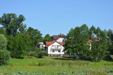 Bright, doll-like, stylish houses, private buildings are located around the amazing nature, the Bug River in the village of Ribenko-Nova of Gmina Wyszkw, within Wyszkw County, Masovian Voivodeship, in east-central Poland.