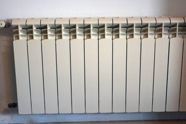 Construction materials and accessories, heating electronic radiator installed on the wall of the house.