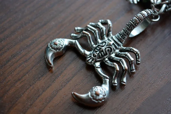 Small Metal Scorpion Carved Ornaments Placed Brown Wooden Table — Stock Photo, Image