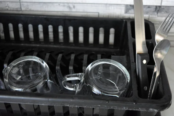 Two Washed Clear Glass Cups Cutlery Beautifully Arranged Black Plastic — Zdjęcie stockowe