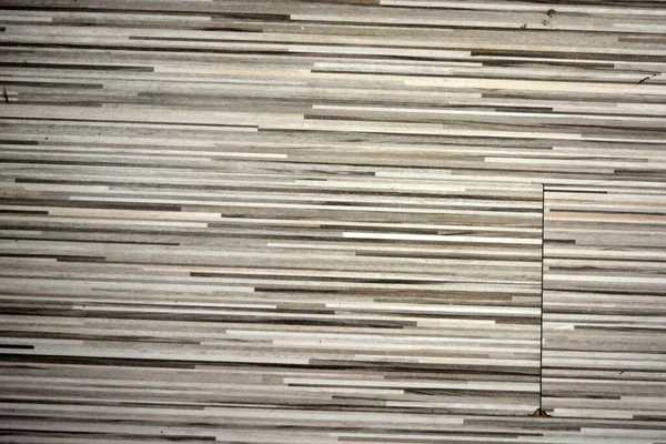 An interesting wooden textured background consists of white, black, gray, beige stripes, emitting a tree, a building textured coating.